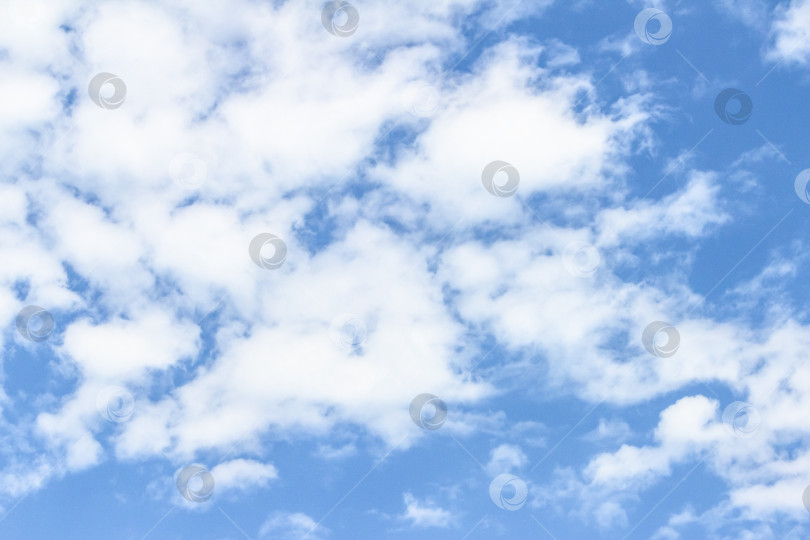 Скачать Ярко-голубое небо с разбросанными по нему пушистыми белыми облаками создает безмятежную и умиротворяющую атмосферу, идеально подходящую для создания фона и дизайна на природную тематику. фотосток Ozero