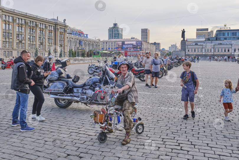Скачать Люди собираются вокруг мотоциклов на общественном городском мероприятии. Самодельный мотороллер фотосток Ozero