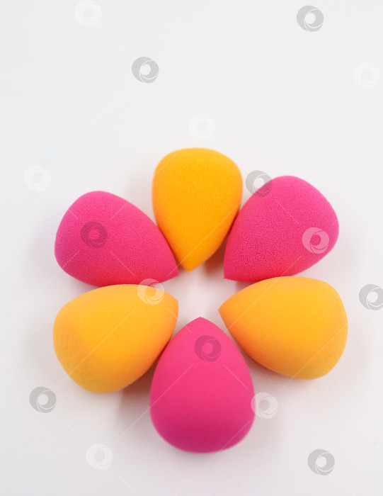 Скачать розовые и оранжевые косметические губки на фоне светлого дерева, крупным планом фотосток Ozero