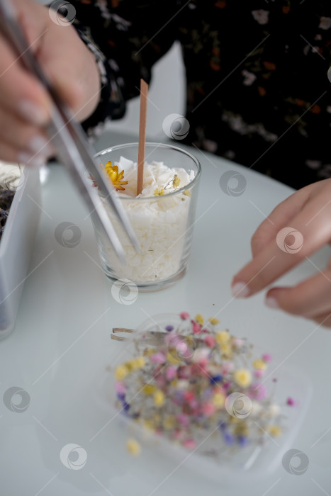 Скачать украшение в виде свечи в банке, изготовление свечей. Свеча, сделанная руками женщины. Плоская форма, вид сверху. Синий фон фотосток Ozero