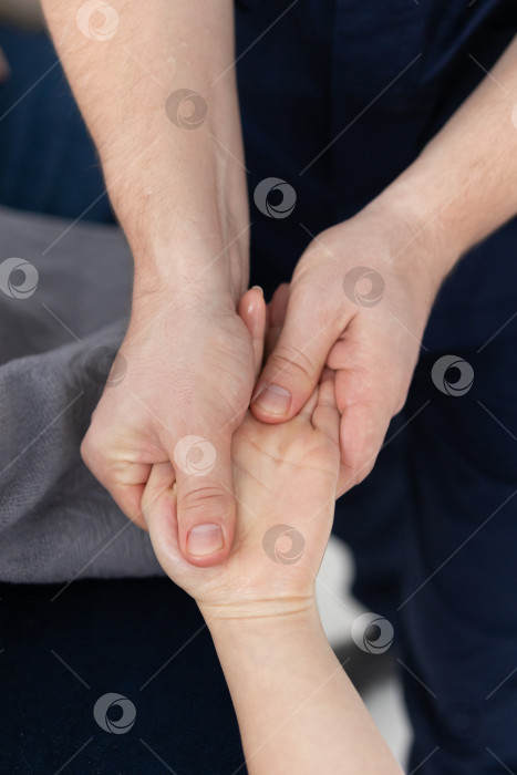 Скачать Массаж рук крупным планом.Профессиональный массажист делает женщине массаж рук фотосток Ozero