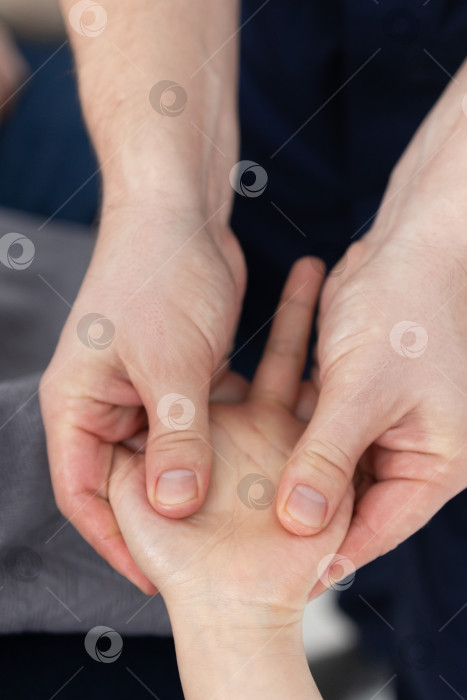 Скачать Массаж рук крупным планом.Профессиональный массажист делает женщине массаж рук фотосток Ozero