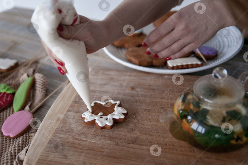 Скачать Сырое пасхальное печенье и формочки для печенья на бумаге для выпечки, вид сверху. Фотографии высокого качества. руки кондитера в перчатках фотосток Ozero