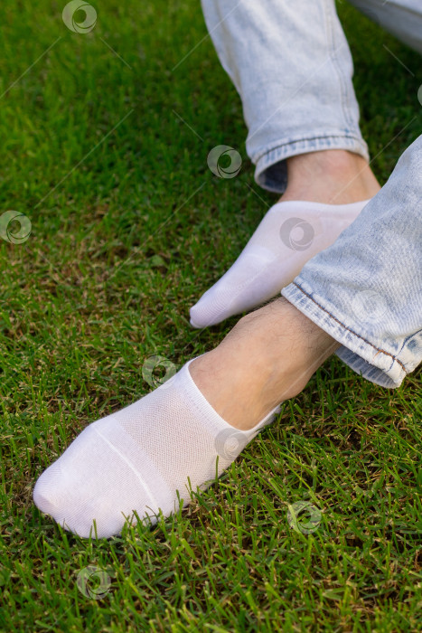 Скачать Мужская нога в белом носке на фоне травы. Мужская нога в носке. фотосток Ozero