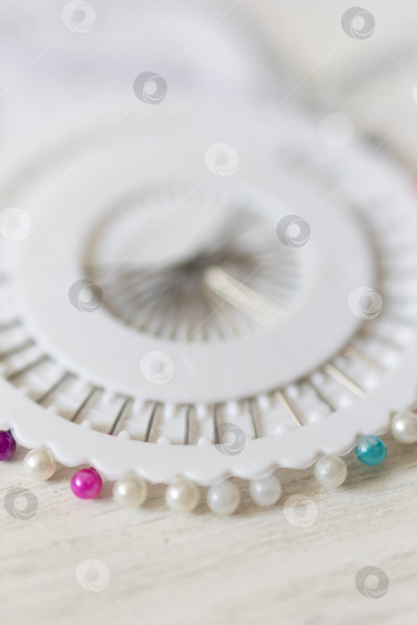 Скачать Закрепляющие булавки на ткани. белый фон фотосток Ozero