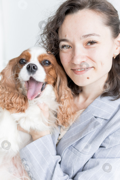 Скачать женщина держит на руках кинг Чарльз спаниеля фотосток Ozero