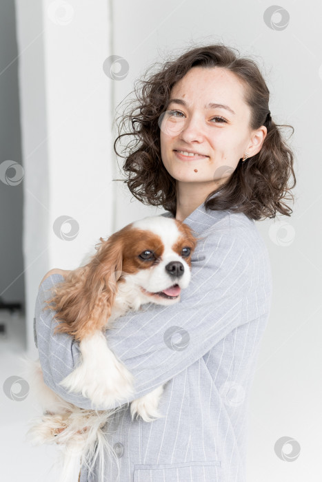 Скачать женщина держит на руках кинг Чарльз спаниеля фотосток Ozero