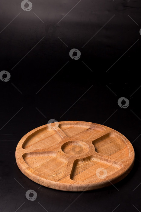 Скачать Пустая круглая минажница из дерева на черном фоне фотосток Ozero