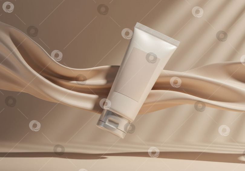 Скачать Макет тюбика средства по уходу за кожей для косметического бренда. Упаковка косметики на фоне бежевой шелковой ткани. Пустой тюбик крема с тенью от листьев растения. фотосток Ozero