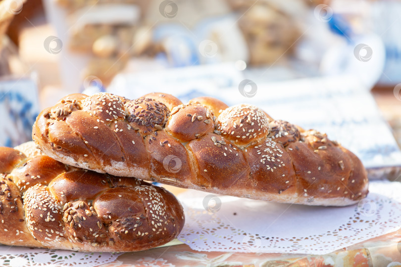 Скачать Красивый плетеный батон, посыпанный кунжутом. Хороший урожай зерна. фотосток Ozero
