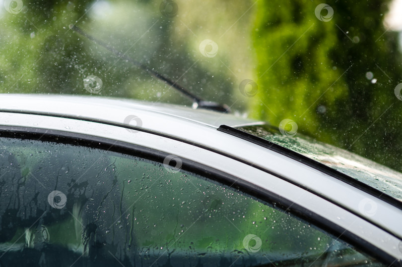 Скачать Сильный летний дождь барабанит по крыше автомобиля фотосток Ozero