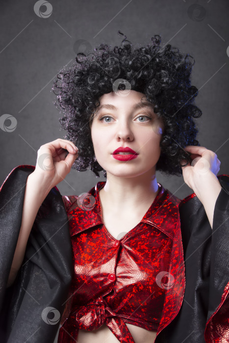 Скачать Забавная винтажная женщина в африканском парике на сером фоне. Девушка с дискотеки. фотосток Ozero