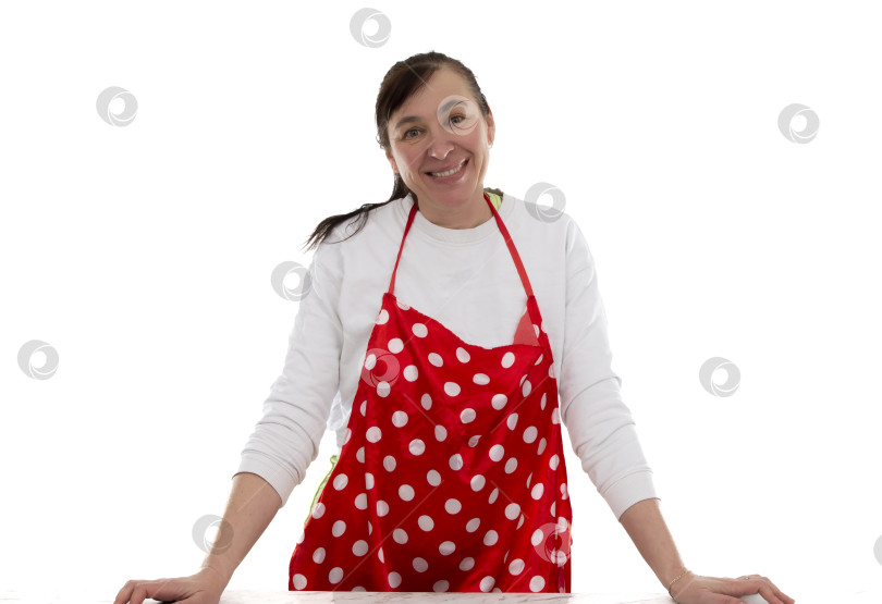 Скачать Женщина средних лет в кулинарном фартуке в красный горошек на белом фоне. фотосток Ozero