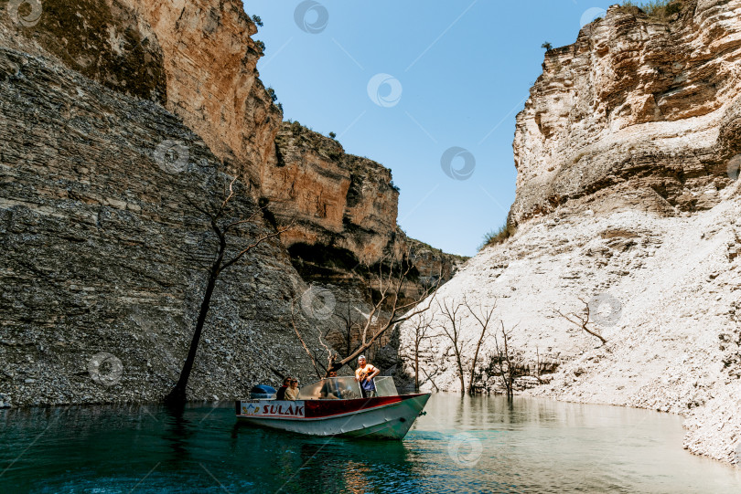 Скачать Дагестан, Россия, 8 мая 2020 года, лодка с туристами плывет по Чиркейскому водохранилищу фотосток Ozero