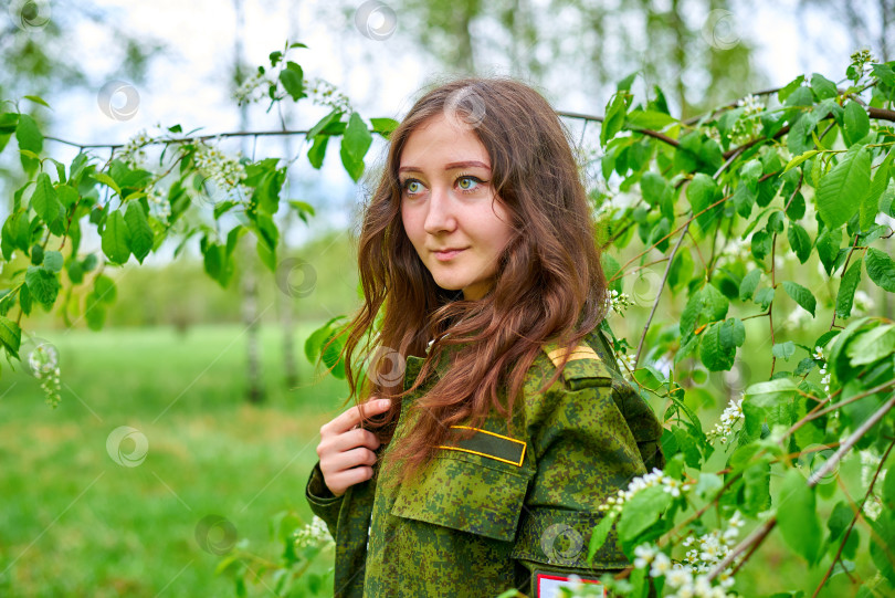 Скачать Женщина в военной форме стоит в лесу фотосток Ozero