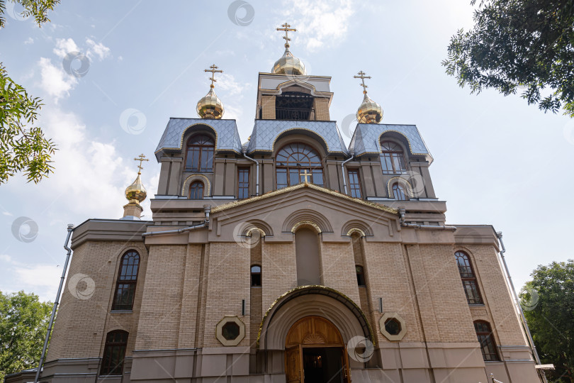 Скачать Православная церковь целителя Пантелеймона. Кирпичный храм с несколькими куполами, украшенными крестами фотосток Ozero