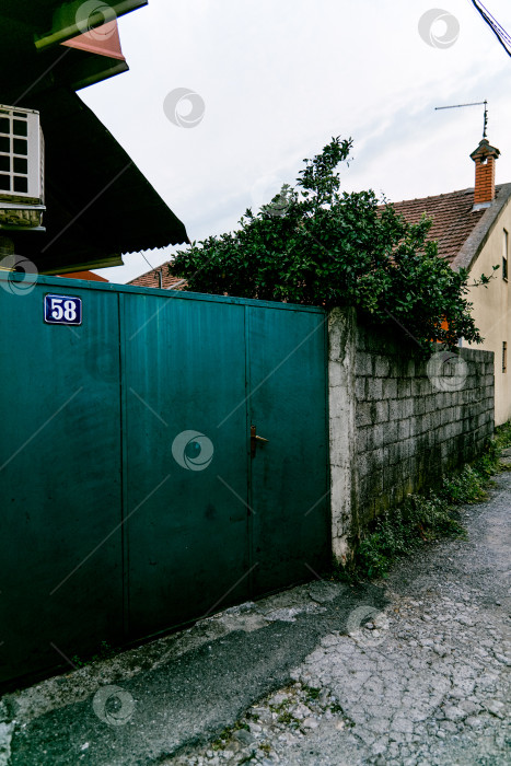 Скачать Стари Бар, Черногория, 2 апреля 2024 года, Входная дверь небольшого жилого дома по соседству, внешнее здание снаружи фотосток Ozero