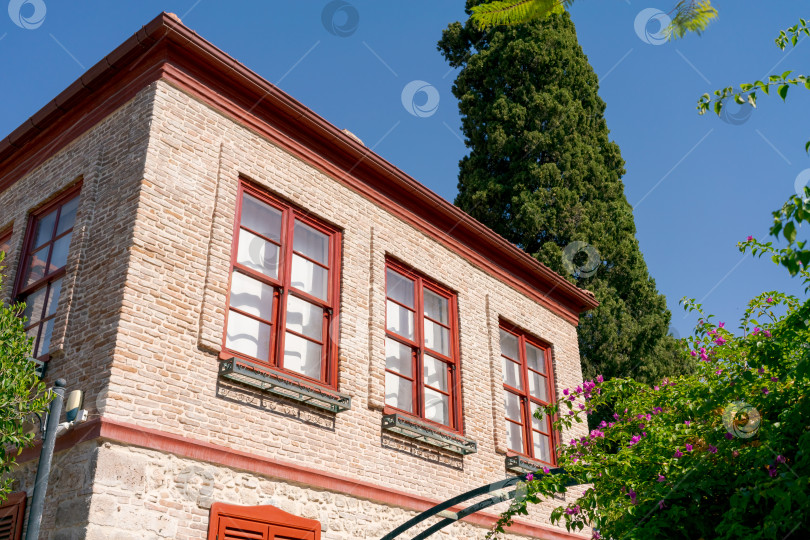 Скачать Кирпичное здание с тремя окнами и красной крышей фотосток Ozero