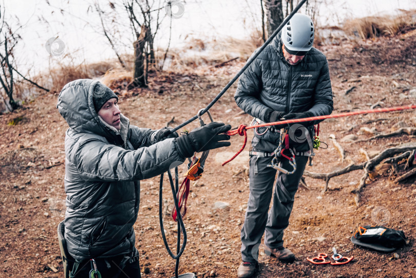 Скачать Санкт-Петербург, Россия, 4 января 2020 года, Скалолаз завязывает узел на веревке фотосток Ozero