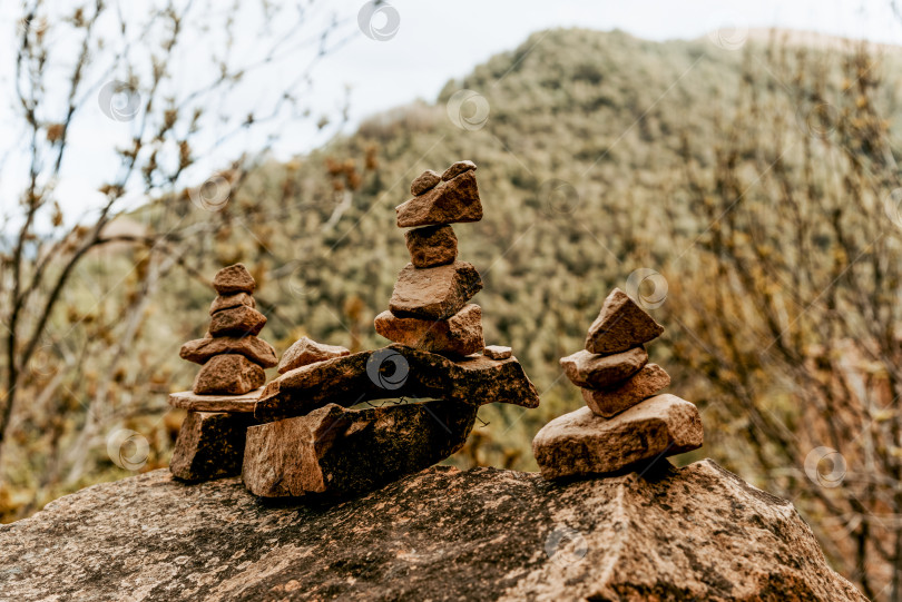 Скачать Маленькие камешки, сложенные пирамидками на больших булыжниках, создают дзен-баланс в природе фотосток Ozero