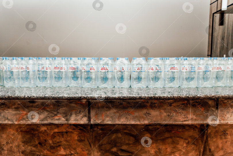 Скачать Москва, Россия, 1 мая 2021 года, Закрытые упаковки бутылочной минеральной воды "Святой источник" фотосток Ozero