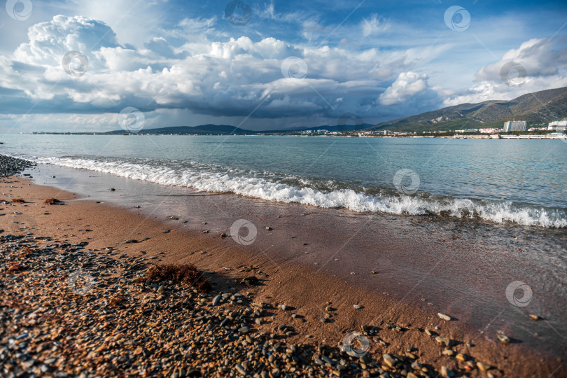 Скачать Курорт Геленджик. Пляж со скалистой береговой линией и облачным небом фотосток Ozero