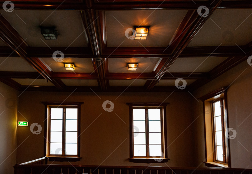 Скачать Интерьер деревянной лестницы с теплым освещением, решетчатым потолком и окнами фотосток Ozero