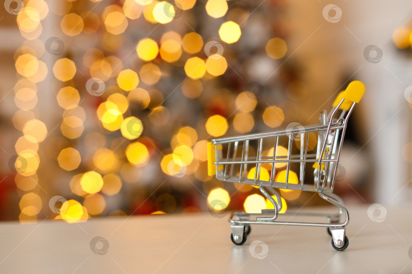 Скачать тележка с продуктами на столе на фоне гирлянд в стиле боке фотосток Ozero