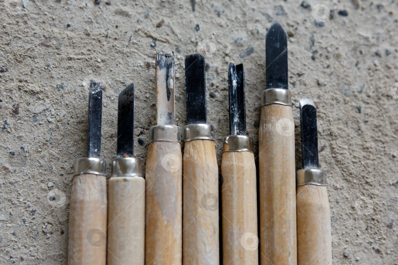 Скачать Инструменты для вырезания барельефа на бетонном фоне фотосток Ozero