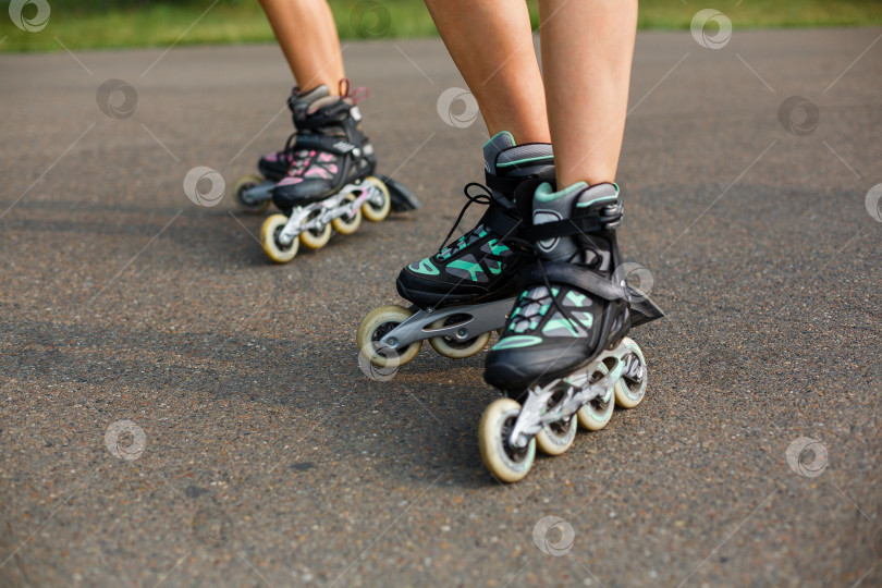 Скачать ножки спортивных девушек прогуливаются на роликовых коньках фотосток Ozero