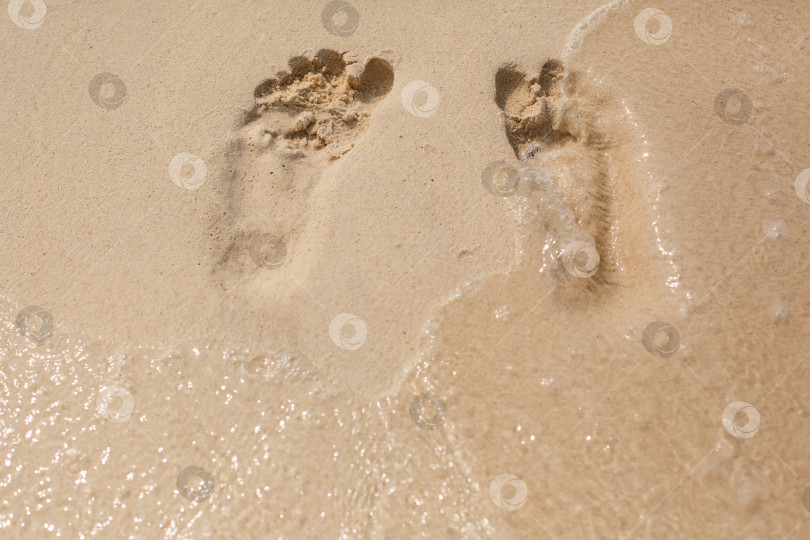 Скачать Естественная текстура и фон. Отпечатки ног на желтом песке на пляже фотосток Ozero