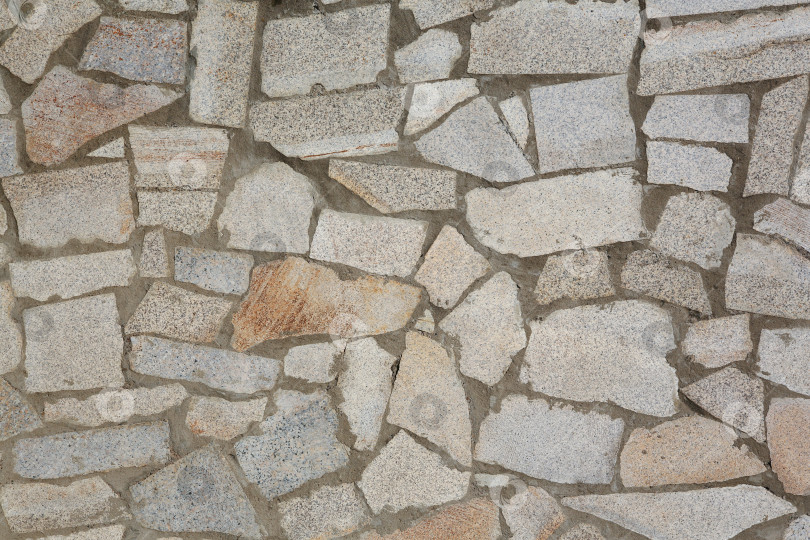 Скачать Естественная текстура и фон. Стена из кусочков колотого гранита фотосток Ozero
