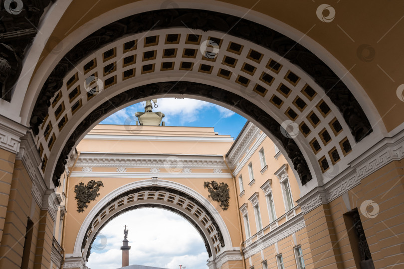 Скачать Историческая арка и колонна в городском пейзаже на фоне голубого неба фотосток Ozero