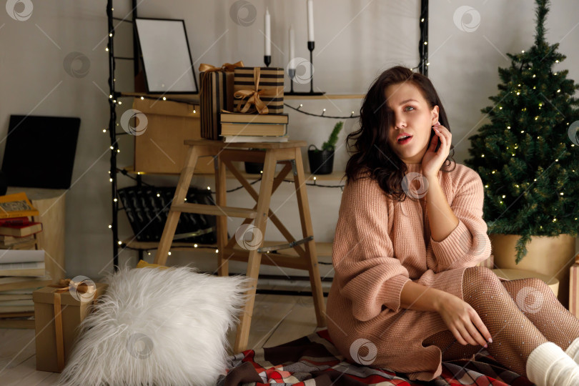 Скачать женщина удивлена и шокирована, находясь в комнате, украшенной к Рождеству фотосток Ozero