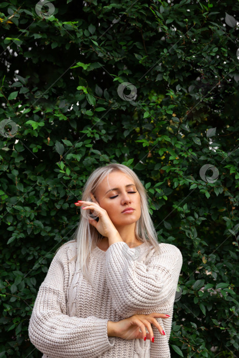 Скачать женщина, стоящая на фоне стены из листьев фотосток Ozero