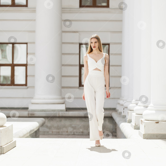 Скачать Портрет молодой красивой блондинки-модели в белых брюках фотосток Ozero