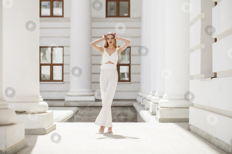 Скачать Портрет молодой красивой блондинки-модели в белых брюках фотосток Ozero