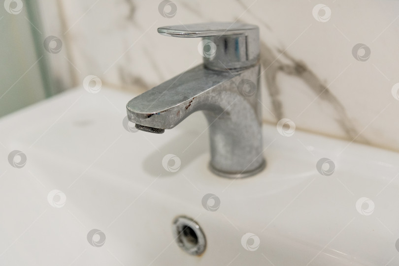 Скачать Грязный хромированный кран в ванной комнате покрылся налетом извести из-за жесткой воды фотосток Ozero
