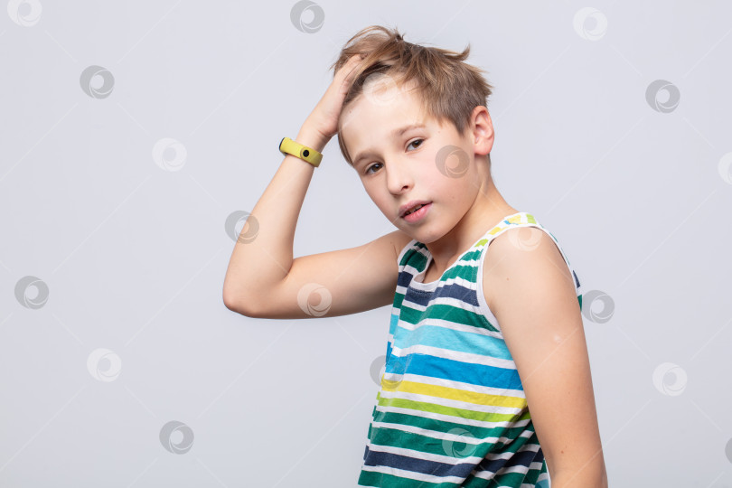 Скачать Молодой человек стильно позирует на нейтральном фоне, демонстрируя игривое выражение лица и повседневную моду в яркую полоску фотосток Ozero