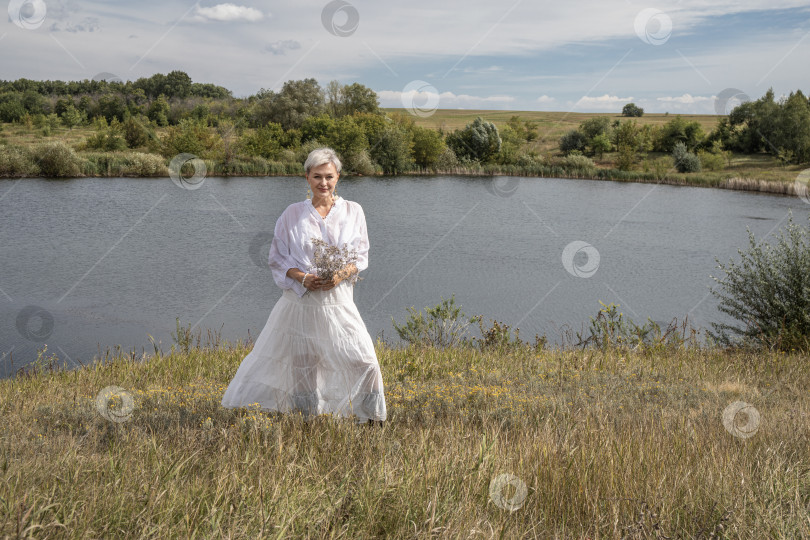 Скачать Портрет женщины средних лет в полный рост на фоне озера фотосток Ozero