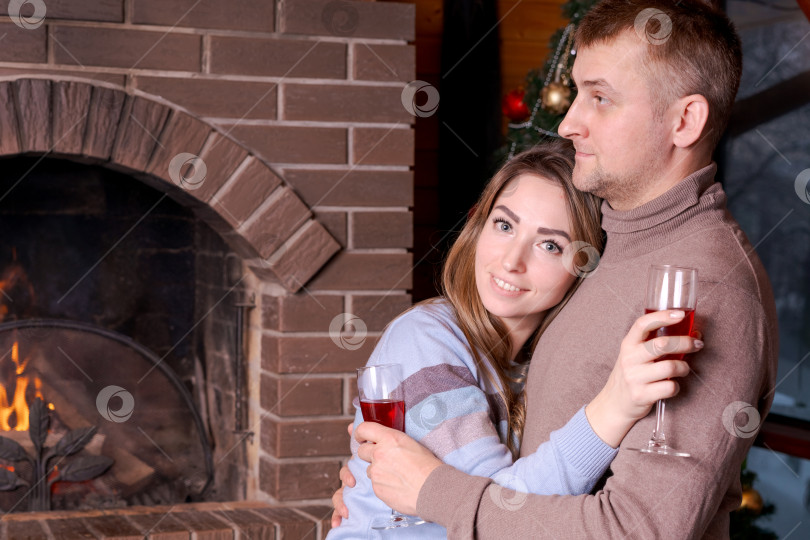 Скачать Мужчина и женщина обнимаются и держат в руках бокалы с вином фотосток Ozero