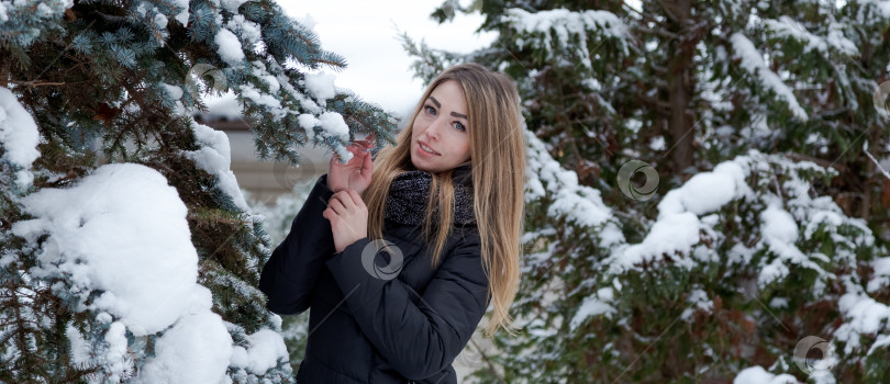 Скачать Женщина стоит в снегу, обхватив руками дерево фотосток Ozero