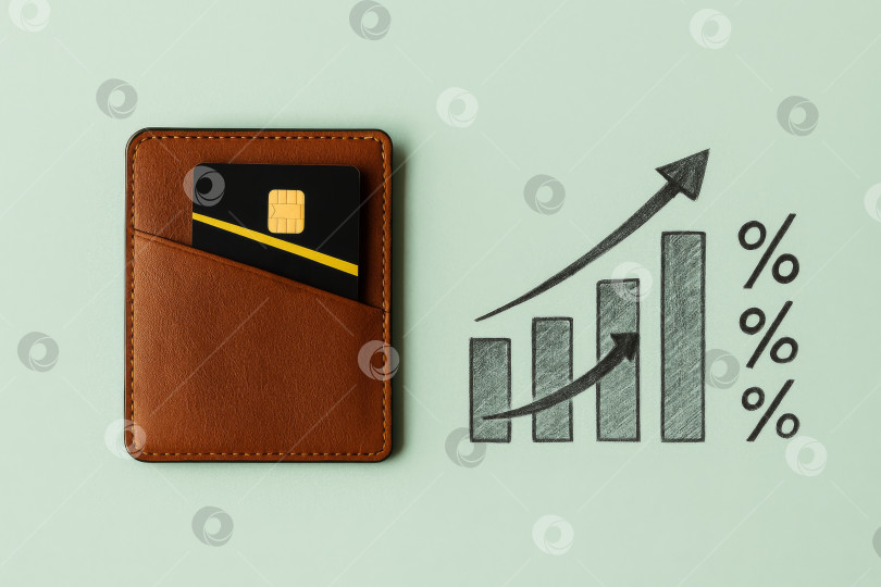 Скачать Кошелек и кредитная карта с графиком роста, иллюстрирующим увеличение финансовых затрат фотосток Ozero