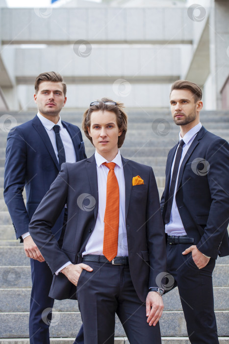 Скачать Трое молодых людей в элегантных деловых костюмах фотосток Ozero