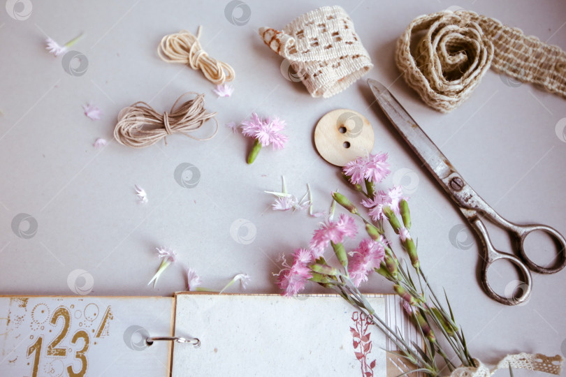Скачать Винтажный фон, ручная работа. Старые ножницы, ленты, деревянные пуговицы, блокнот для текста и цветы. фотосток Ozero