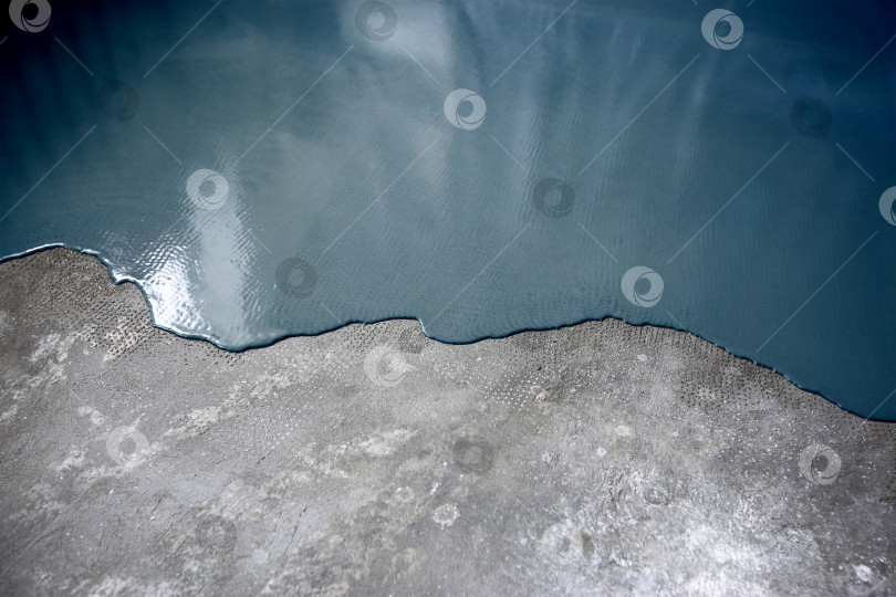 Скачать Бетонный пол выкрашен в темно-синий цвет. Подрядчик покрасит пол в гараже, чтобы ускорить продажу дома фотосток Ozero