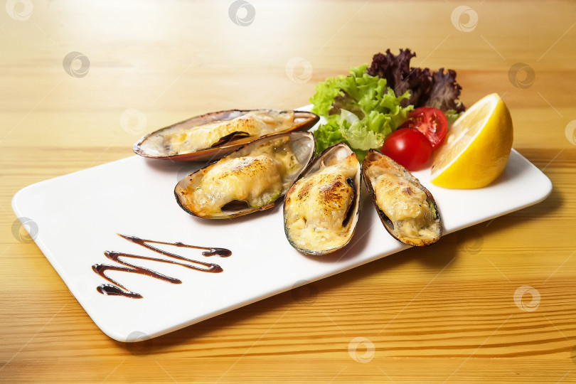 Скачать Мидии с сыром, запеченные в ракушке. Европейская кухня. фотосток Ozero