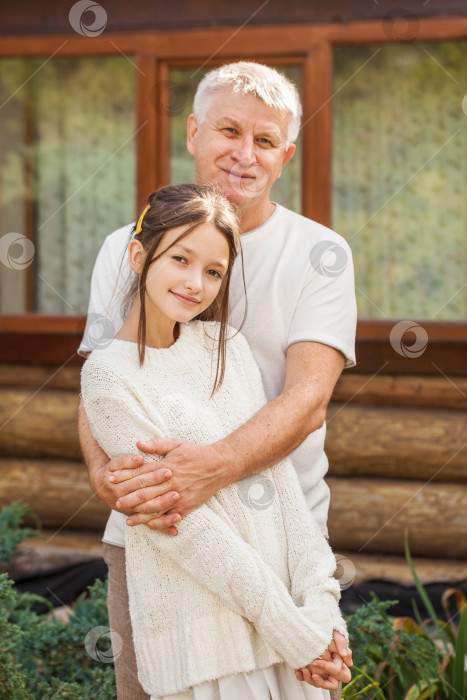 Скачать Семейный портрет - Седовласый дедушка обнимает свою внучку фотосток Ozero