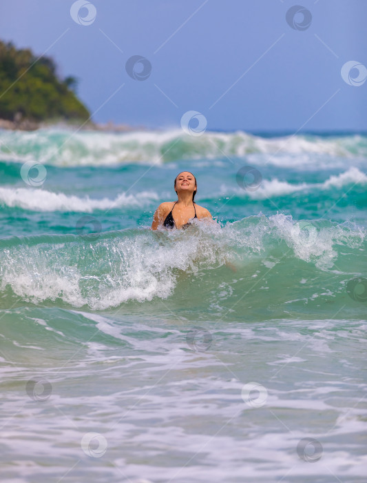 Скачать Молодая красивая девушка от счастья прыгает в море, радуется волнам фотосток Ozero