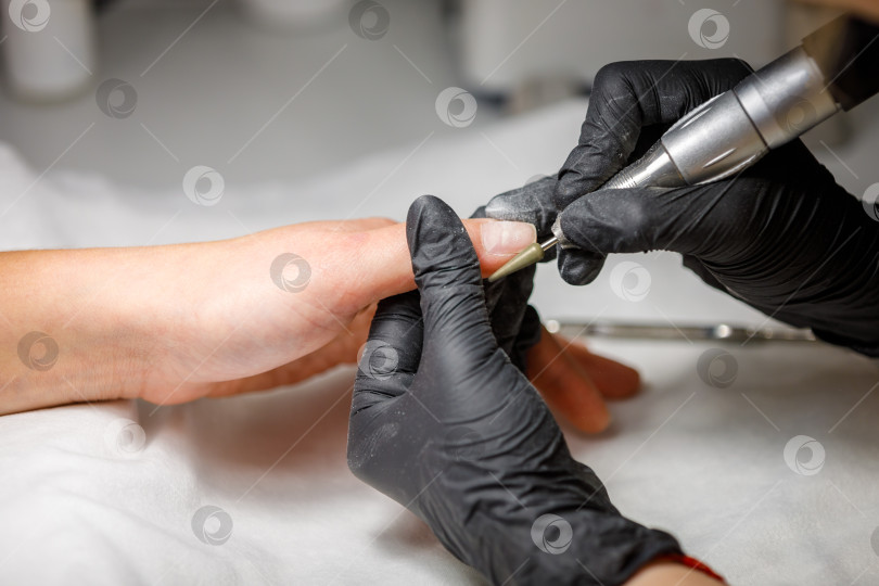 Скачать В студии красоты мастер делает аппаратный маникюр. Снятие гель-лака фрезой фотосток Ozero